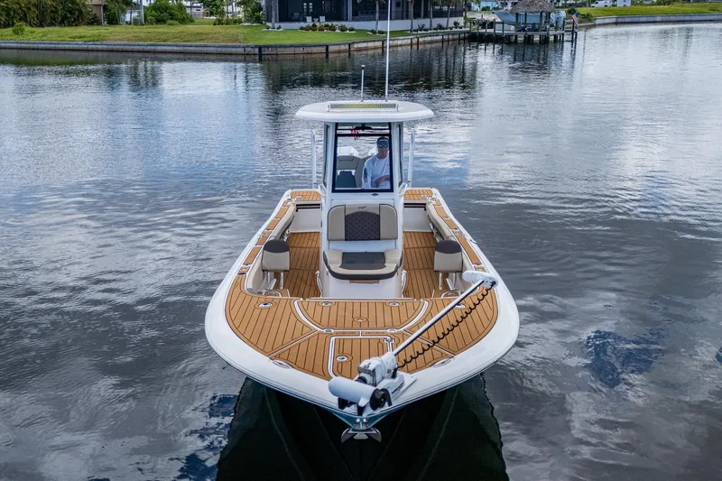  Yacht Photos Pics 2023 Tidewater 2700 Carolina Bay boat on calm water, featuring spacious deck and modern design.