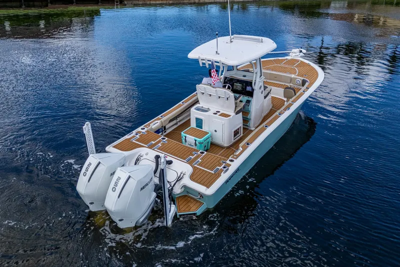  Yacht Photos Pics 2023 Tidewater 2700 Carolina Bay boat on calm water, featuring dual outboard motors.