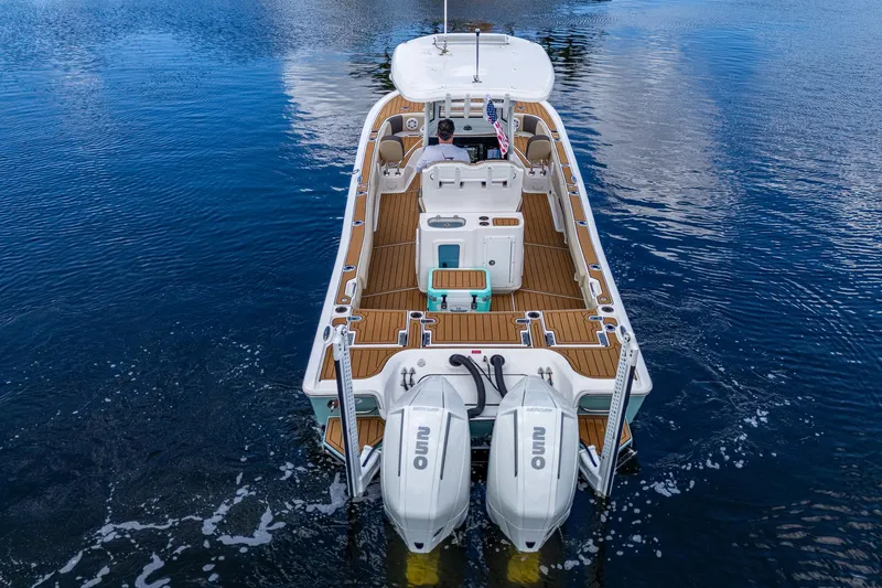  Yacht Photos Pics 2023 Tidewater 2700 Carolina Bay boat on water, featuring dual outboard engines.