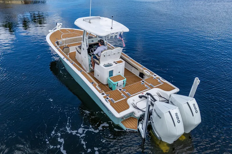  Yacht Photos Pics 2023 Tidewater 2700 Carolina Bay boat on water, featuring dual Mercury engines.