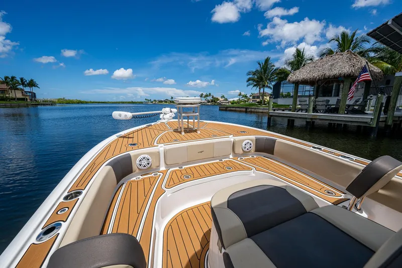  Yacht Photos Pics 2023 Tidewater 2700 Carolina Bay boat on scenic waterfront with clear blue sky.