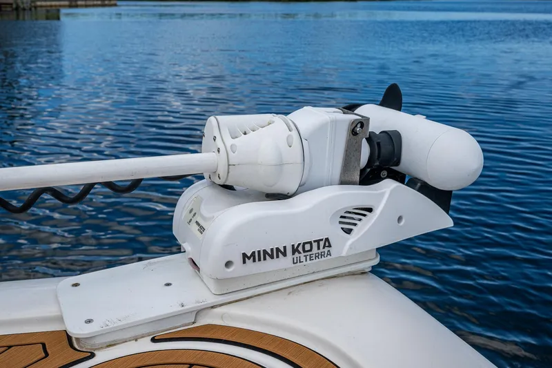  Yacht Photos Pics Minn Kota Ulterra motor on 2023 Tidewater 2700 Carolina Bay boat, docked on calm water.