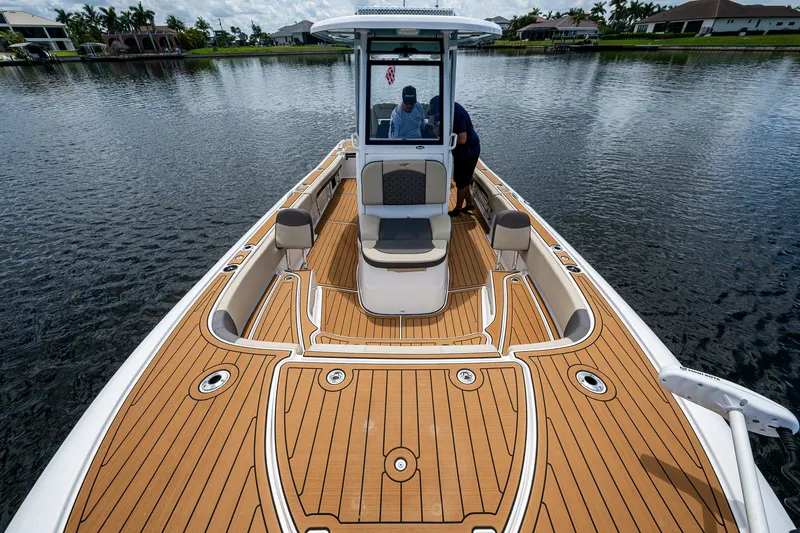  Yacht Photos Pics 2023 Tidewater 2700 Carolina Bay boat on water, featuring spacious deck and seating.