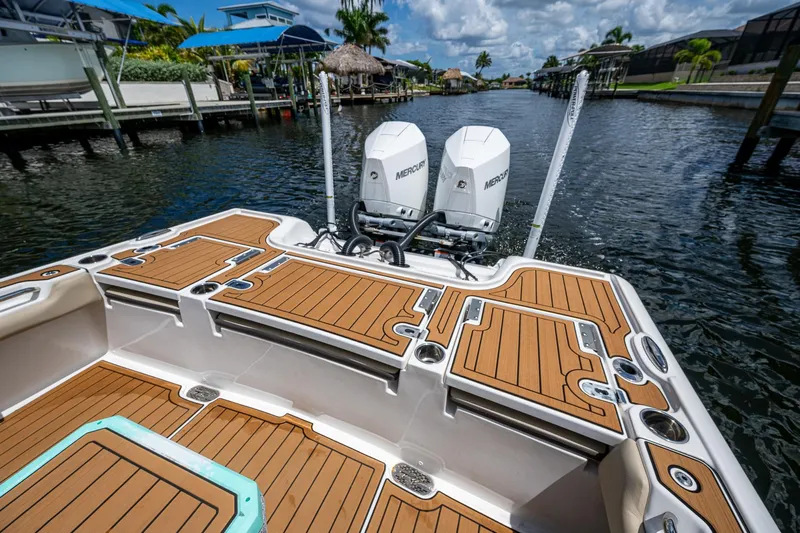  Yacht Photos Pics 2023 Tidewater 2700 Carolina Bay boat with dual Mercury engines on a sunny waterway.
