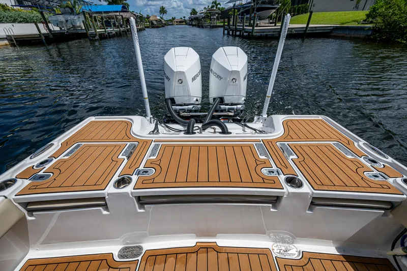  Yacht Photos Pics 2023 Tidewater 2700 Carolina Bay boat with dual Mercury engines on a calm waterway.