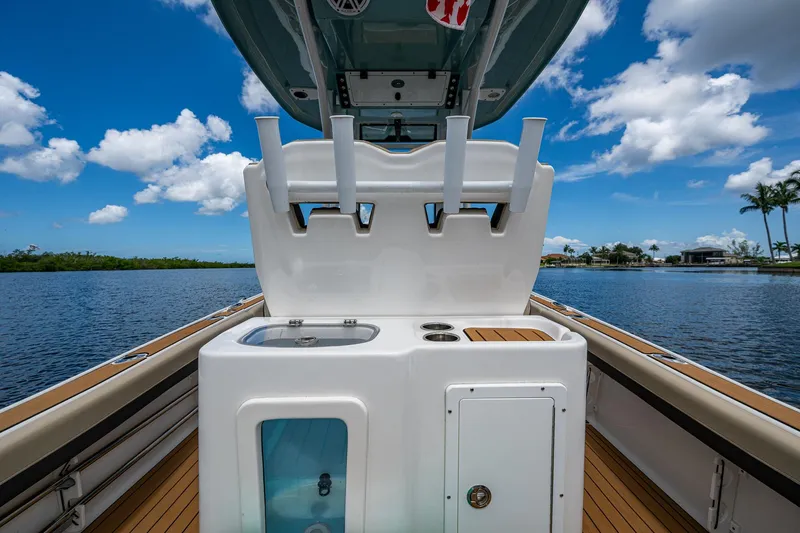  Yacht Photos Pics 2023 Tidewater 2700 Carolina Bay boat interior with rod holders and sink, on a sunny day.