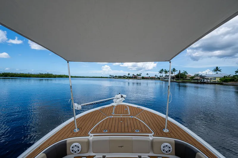  Yacht Photos Pics 2023 Tidewater 2700 Carolina Bay boat on calm water under a canopy.