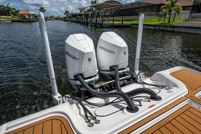 Yacht Photos Pics 2023 Tidewater 2700 Carolina Bay boat with dual Mercury engines on a sunny waterway.