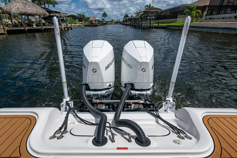  Yacht Photos Pics 2023 Tidewater 2700 Carolina Bay boat with dual Mercury engines on a scenic waterway.