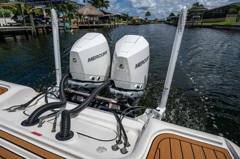  Yacht Photos Pics 2023 Tidewater 2700 Carolina Bay boat with dual Mercury engines on a scenic waterway.
