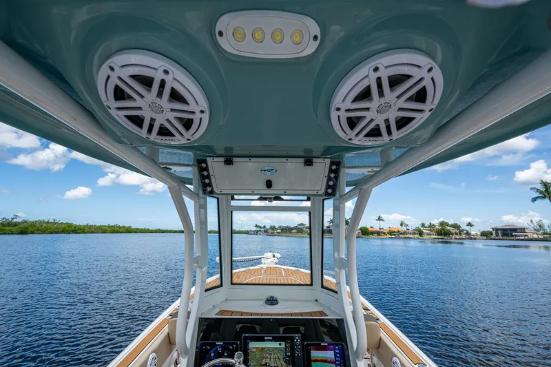 Yacht Photos Pics 2023 Tidewater 2700 Carolina Bay boat interior with speakers and navigation system on a sunny day.