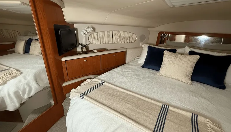 Optics Yacht Photos Pics Luxurious 1999 Sea Ray 420 Aft Cabin bedroom with elegant decor and cozy bedding.