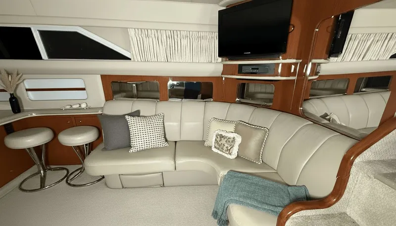 Optics Yacht Photos Pics Luxurious interior of 1999 Sea Ray 420 Aft Cabin yacht with plush seating and modern amenities.