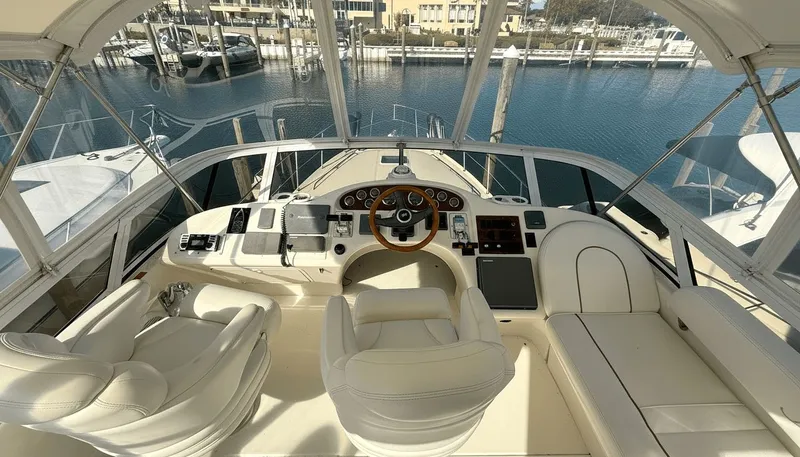 Optics Yacht Photos Pics Luxurious helm of a 1999 Sea Ray 420 Aft Cabin yacht with marina view.