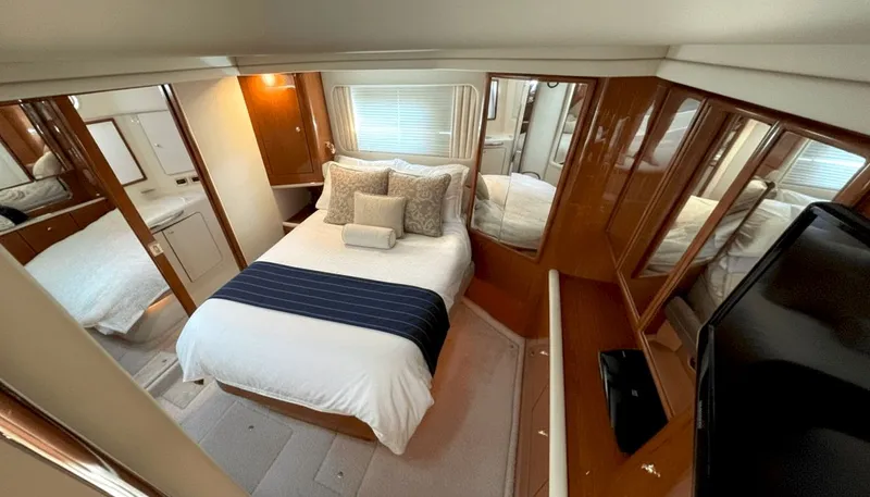 Optics Yacht Photos Pics Luxurious 1999 Sea Ray 420 Aft Cabin interior with elegant bedroom and modern amenities.