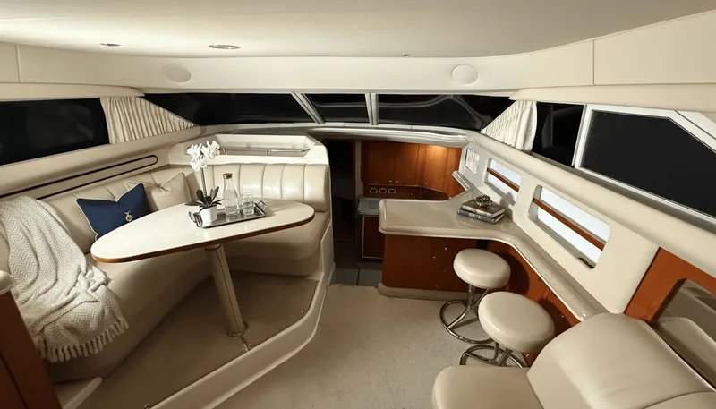 Optics Yacht Photos Pics Luxurious interior of a 1999 Sea Ray 420 Aft Cabin yacht with elegant seating and decor.