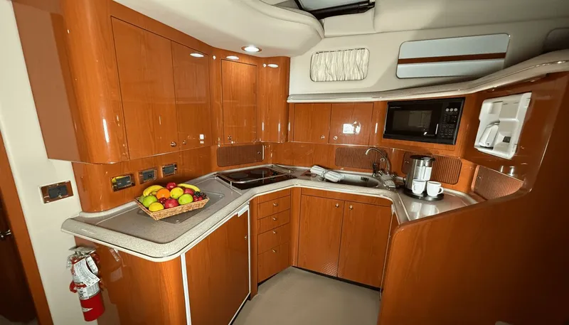 Optics Yacht Photos Pics Luxurious 1999 Sea Ray 420 Aft Cabin kitchen with wood cabinetry and modern appliances.