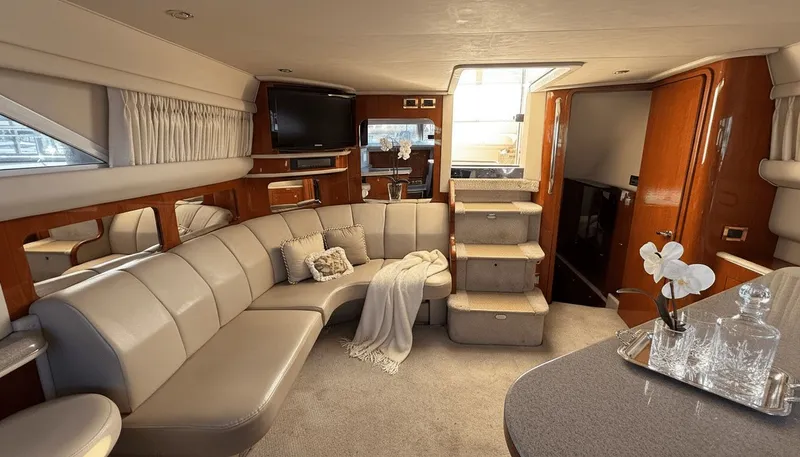 Optics Yacht Photos Pics Luxurious interior of 1999 Sea Ray 420 Aft Cabin yacht with plush seating and elegant decor.