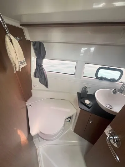 Marea Yacht Photos Pics 2019 Jeanneau Merry Fisher 895 bathroom with sink, toilet, and window.