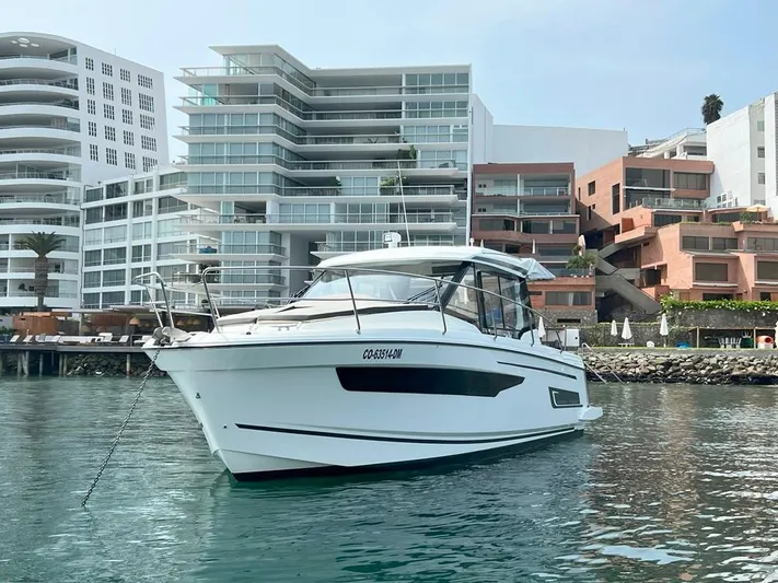 Marea Yacht Photos Pics 2019 Jeanneau Merry Fisher 895 boat docked near modern waterfront buildings.