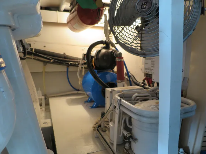 High Risk Yacht Photos Pics Engine room of a 1997 Post 50 Flybridge yacht with various mechanical components.