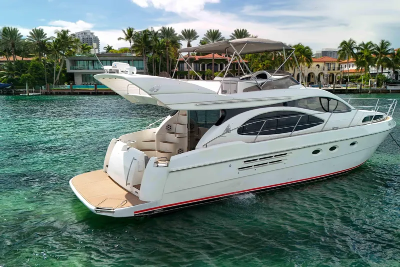  Yacht Photos Pics Luxury 2001 Azimut 46 yacht cruising in tropical waters, surrounded by palm trees.