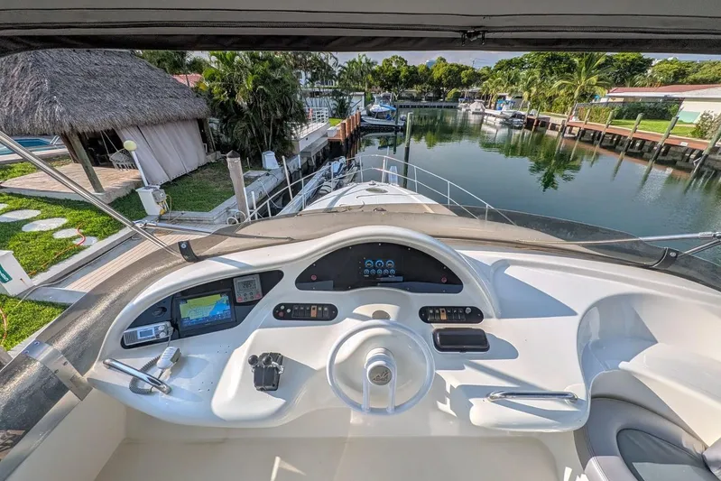  Yacht Photos Pics Cockpit view of a 2001 Azimut 46 yacht docked in a serene marina.