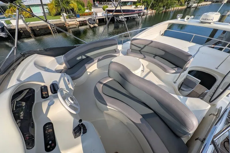  Yacht Photos Pics Luxurious 2001 Azimut 46 yacht with spacious seating and modern helm, docked by the water.