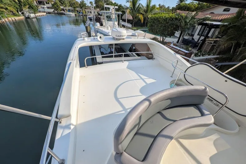  Yacht Photos Pics Flybridge of 2001 Azimut 46 yacht with seating, overlooking serene waterfront.