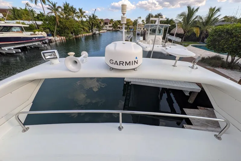  Yacht Photos Pics 2001 Azimut 46 yacht with Garmin equipment, docked in a scenic canal setting.