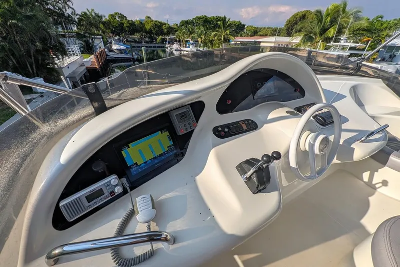  Yacht Photos Pics Cockpit of a 2001 Azimut 46 yacht with modern navigation equipment and steering wheel.