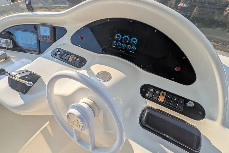  Yacht Photos Pics Control panel of a 2001 Azimut 46 yacht with steering wheel and digital displays.