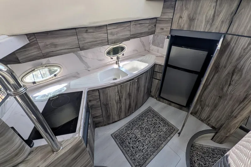  Yacht Photos Pics Luxurious 2001 Azimut 46 yacht kitchen with modern appliances and elegant wood finish.