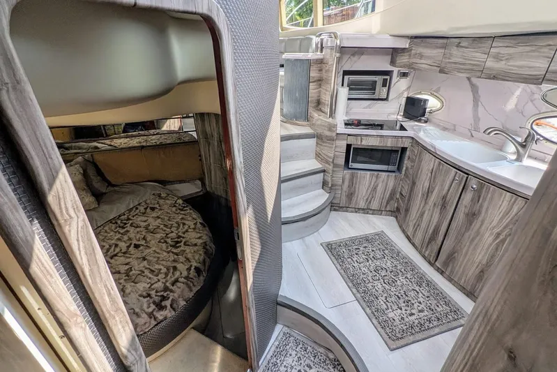  Yacht Photos Pics Luxurious interior of a 2001 Azimut 46 yacht featuring a cozy bedroom and modern kitchen.