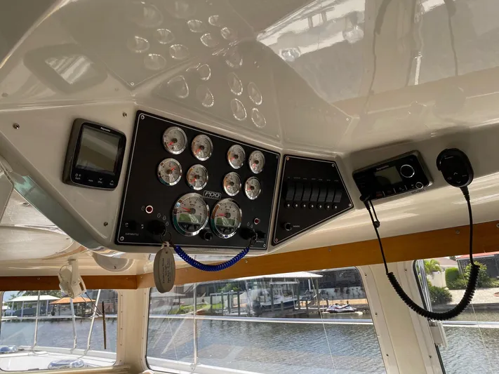 Magic Yacht Photos Pics Control panel of a 2008 PDQ MV-41 boat with gauges and navigation equipment.