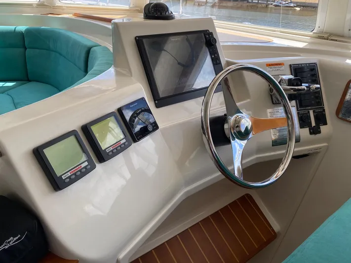 Magic Yacht Photos Pics Steering console of a 2008 PDQ MV-41 boat with modern navigation instruments.