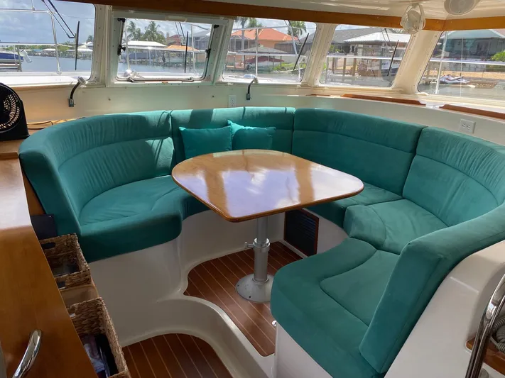 Magic Yacht Photos Pics Luxurious PDQ MV-41 yacht interior with teal seating and wooden table, 2008 model.