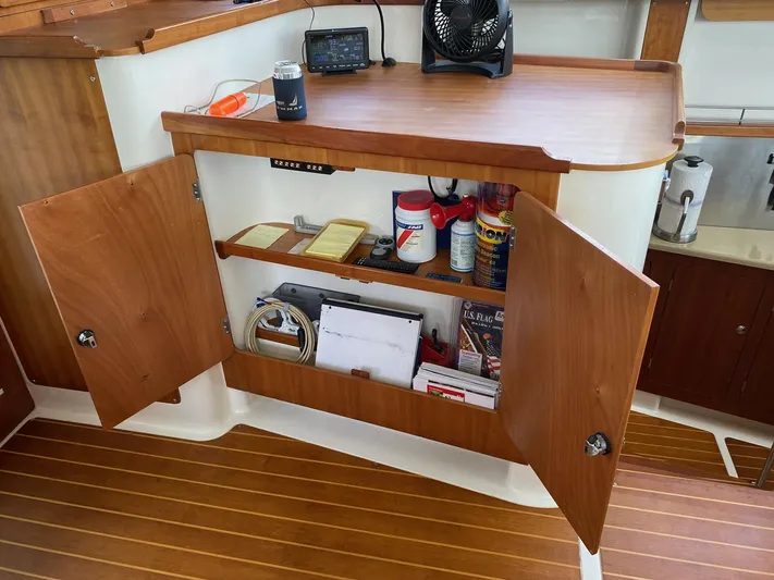 Magic Yacht Photos Pics Open wooden cabinet on PDQ MV-41 boat, displaying shelves with various items, 2008 model.