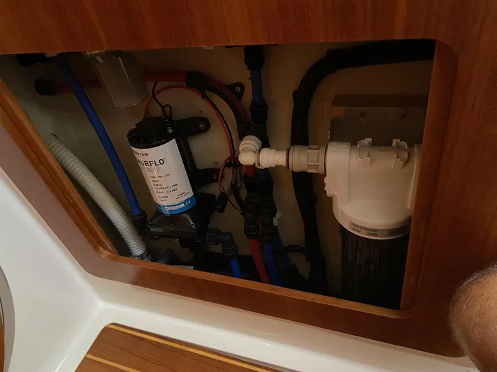 Magic Yacht Photos Pics Boat plumbing system inside a PDQ MV-41, 2008 model, featuring pipes and a water pump.