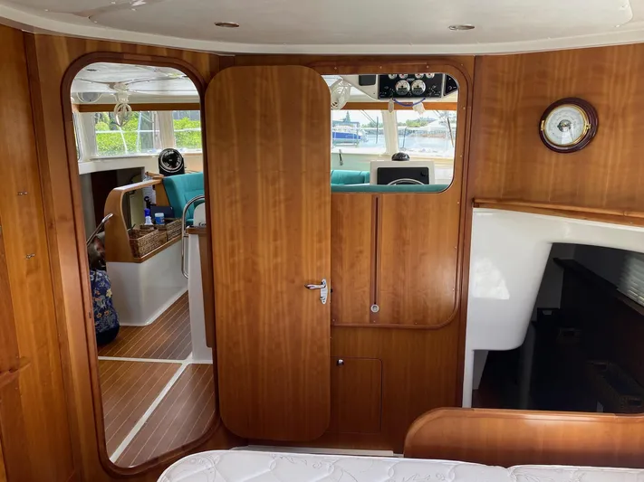 Magic Yacht Photos Pics Interior of 2008 PDQ MV-41 boat with wooden paneling and cozy seating area.