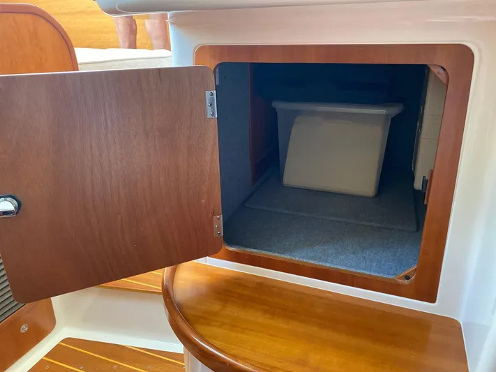Magic Yacht Photos Pics Open wooden cabinet on PDQ MV-41 boat, revealing storage space with a container inside.