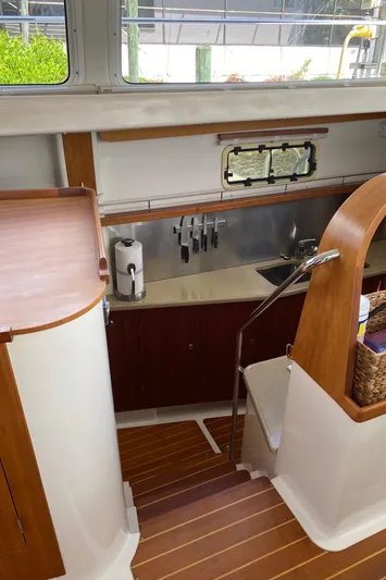 Magic Yacht Photos Pics 2008 PDQ MV-41 yacht interior with wooden cabinetry and compact kitchen area.