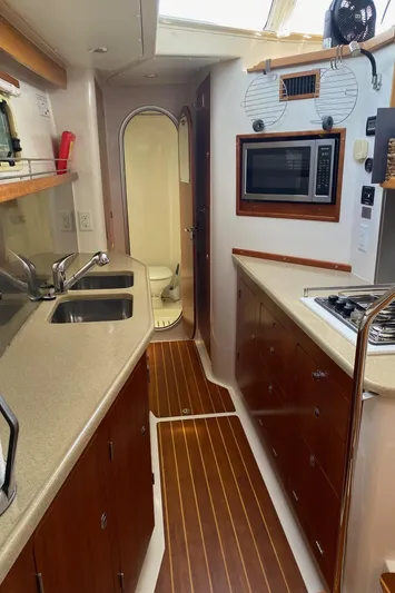 Magic Yacht Photos Pics Compact kitchen in 2008 PDQ MV-41 boat with sink, stove, and microwave.