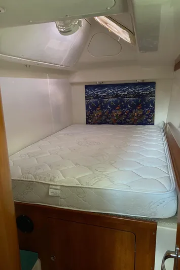 Magic Yacht Photos Pics Cozy cabin interior of 2008 PDQ MV-41 with a comfortable bed and nautical decor.