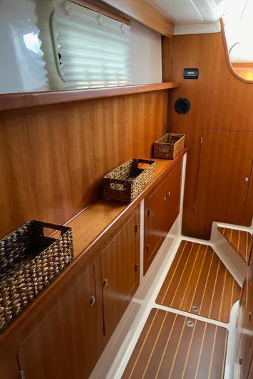 Magic Yacht Photos Pics Interior of 2008 PDQ MV-41 boat with wooden cabinets and wicker baskets.