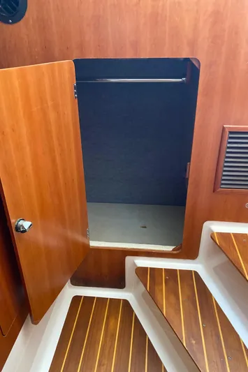 Magic Yacht Photos Pics Wooden interior of a 2008 PDQ MV-41 boat with open storage compartment.