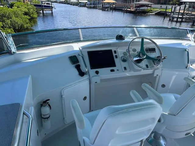 Magic Yacht Photos Pics Helm of 2008 PDQ MV-41 boat with steering wheel and navigation equipment, overlooking a serene waterway.