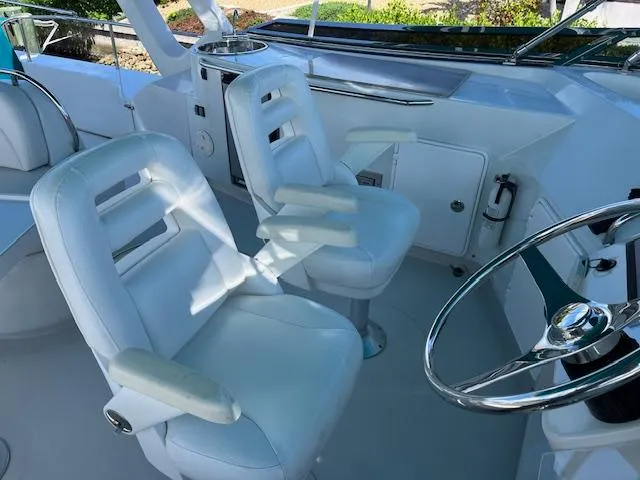 Magic Yacht Photos Pics White captain's chairs and steering wheel on a 2008 PDQ MV-41 boat.