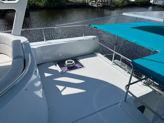 Magic Yacht Photos Pics Deck of 2008 PDQ MV-41 boat with seating and teal canopy, near water.