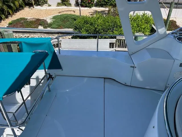 Magic Yacht Photos Pics Upper deck of 2008 PDQ MV-41 boat with teal canopy and railing.